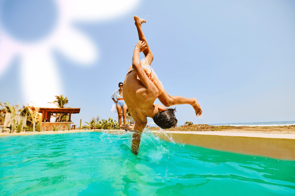 Kid doing front flip into the pool