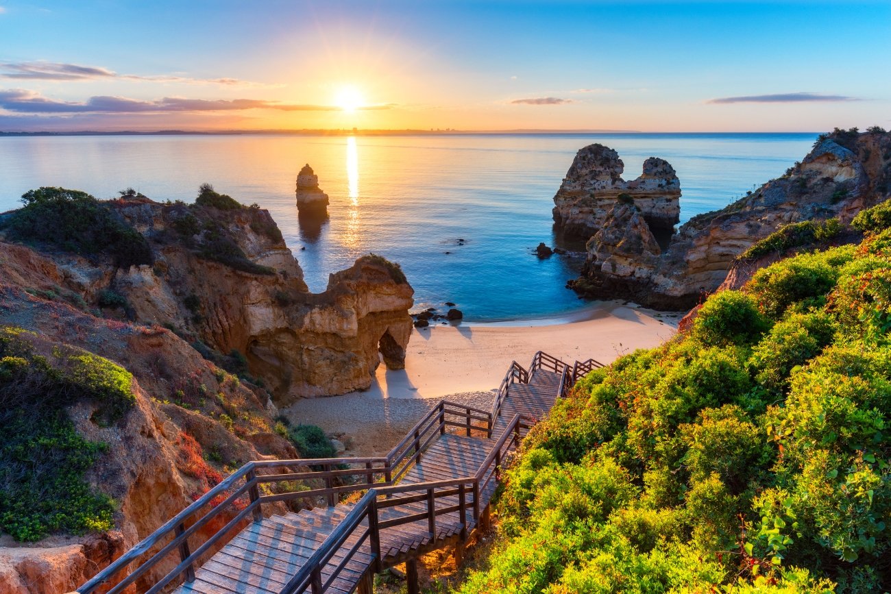 A scenic view of Portugal's Algarve region with beautiful beaches and cliffs.